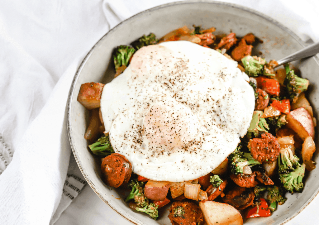 A bowl of chorizo sausage breakfast skillet topped with a fried egg