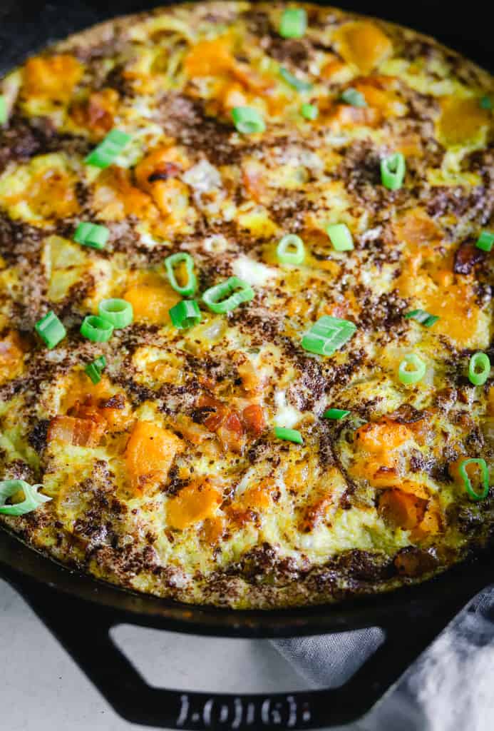A close up view of a kabocha frittata in a cast iron pan