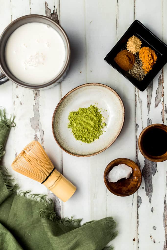 An overview shot of the ingredients needed for an at home starbucks iced matcha latte.