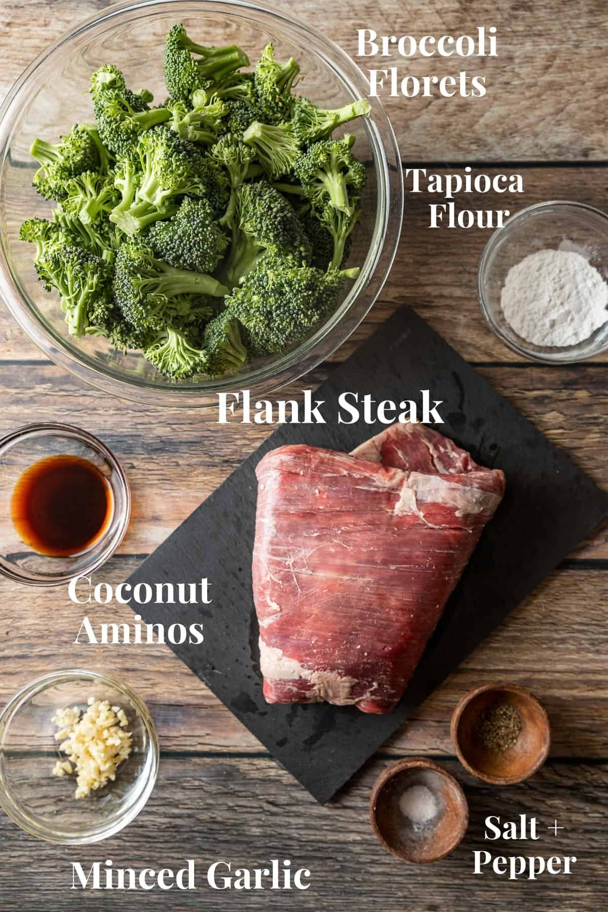 An overview photo of the ingredients needed for beef and broccoli on a wood background.