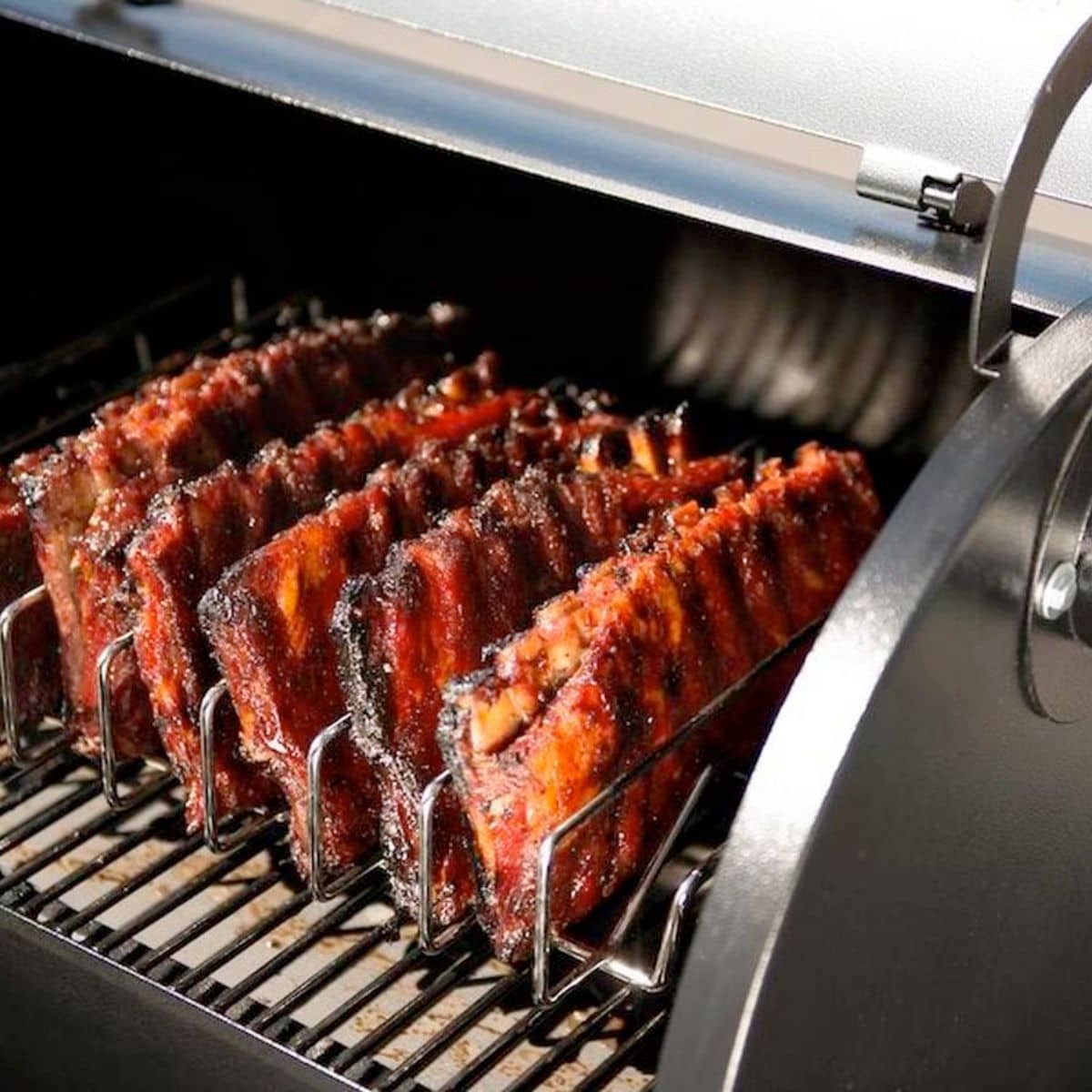 Ribs grilling in rib racks on a traeger grill.